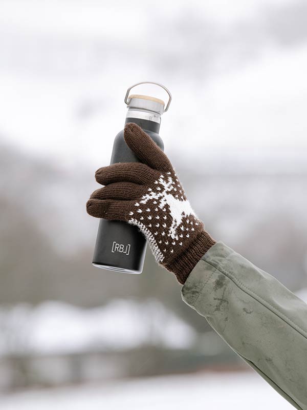 Praktisches Produkt -Thermosflasche in Hand mit Handschuh